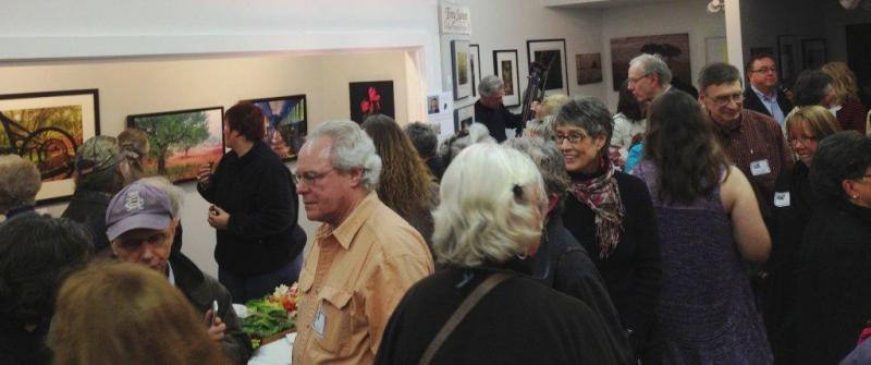 Onlookers gather Friday, April 12 at the Boothbay Region Art Foundation for the Maine Photography Show's awards presentation. Moe Chen's "Sand Beach Nights" was tabbed as the best in show photograph. BEN BULKELEY/Boothbay Register